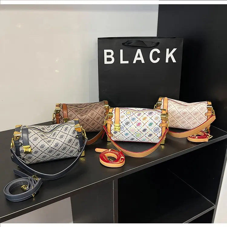 Four handbags with different designs on a black surface, with a 'BLACK' bag in the background.